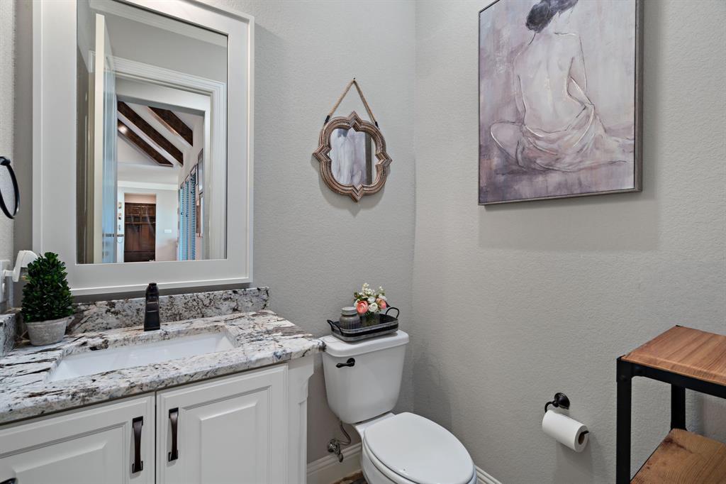 3032 Perkins Weatherford, TX 76088 - Photo 24 of 40 a bathroom with a toilet a sink and mirror