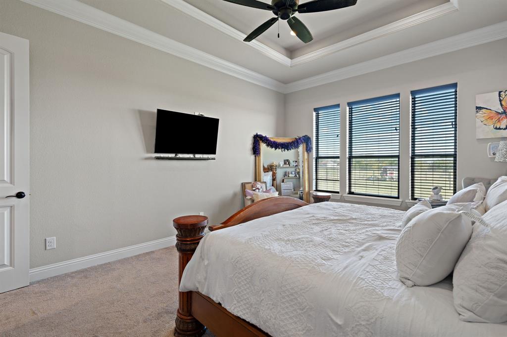 3032 Perkins Weatherford, TX 76088 - Photo 27 of 40 a bedroom with a bed and a flat screen tv
