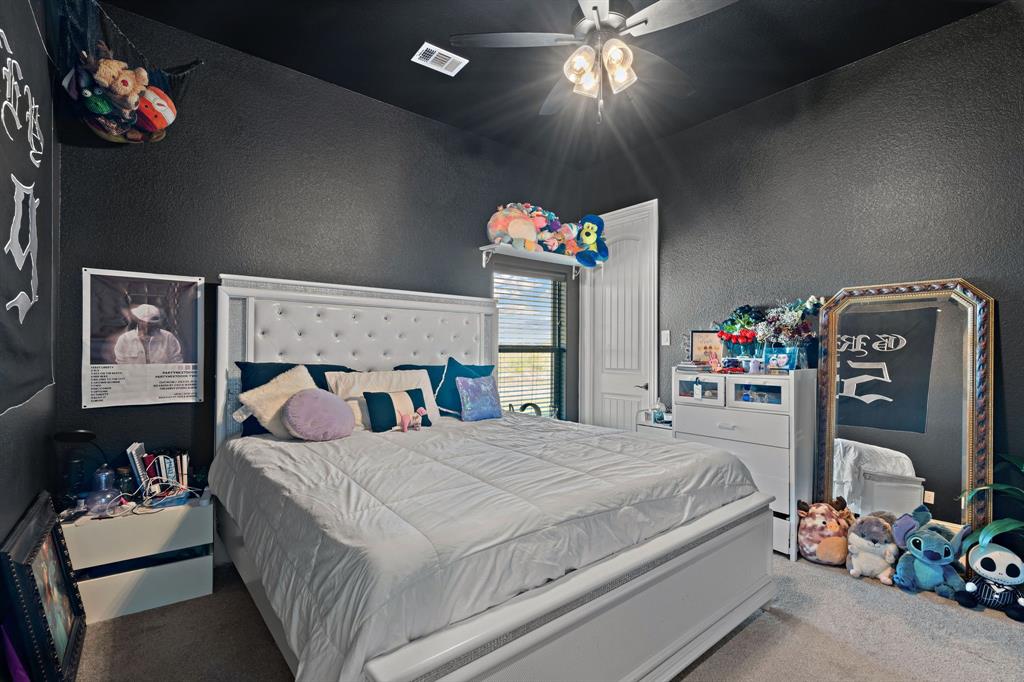 3032 Perkins Weatherford, TX 76088 - Photo 33 of 40 a bedroom with a bed and a chandelier