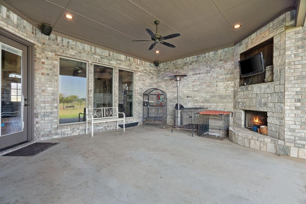 3032 Perkins Weatherford, TX 76088 - Photo 38 of 40 a living room with furniture a fireplace and a flat screen tv