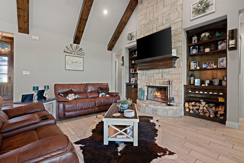 3032 Perkins Weatherford, TX 76088 - Photo 10 of 40 a living room with furniture a flat screen tv and a fireplace