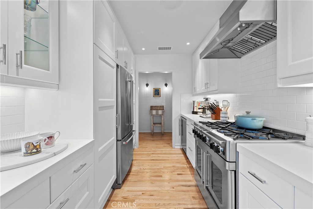320 Broadway Costa Mesa, CA 92627 - Photo 29 of 53 a kitchen with stainless steel appliances a white stove top oven and a refrigerator