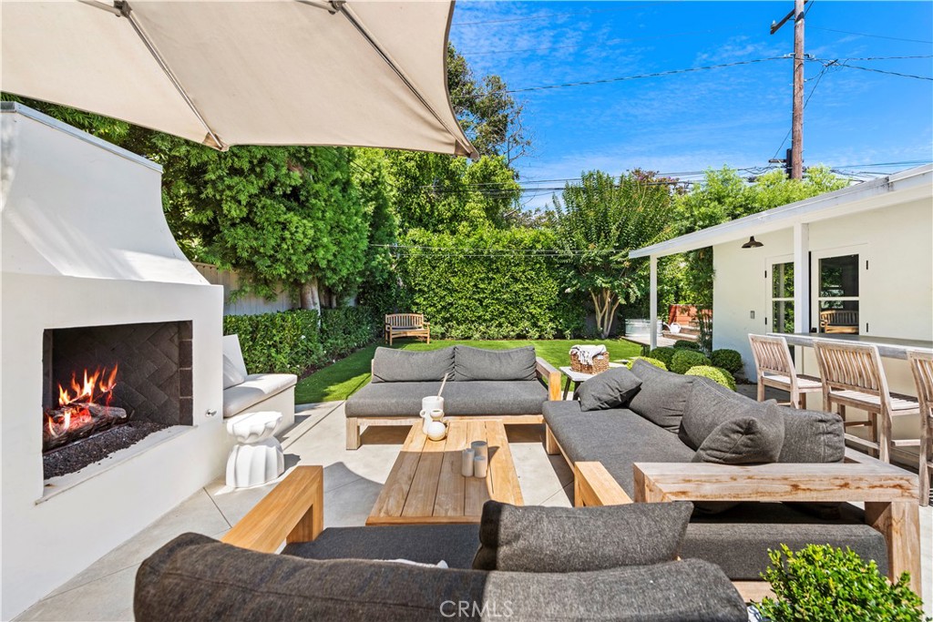 320 Broadway Costa Mesa, CA 92627 - Photo 34 of 53 a view of a patio with couches table and chairs under an umbrella