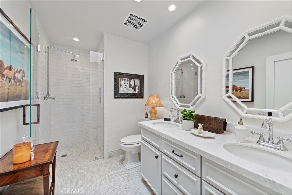 320 Broadway Costa Mesa, CA 92627 - Photo 9 of 53 a spacious bathroom with a granite countertop double vanity sink a mirror and a