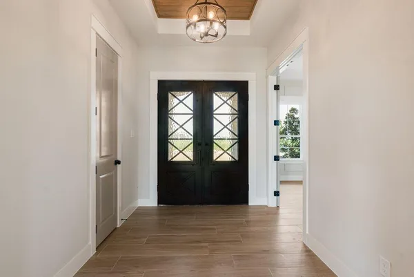 a view of an entryway with wooden floor