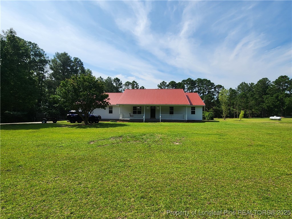 5444 Rockfish Road Raeford, NC 28376 - Photo 1 of 37 a view of a house with a big yard