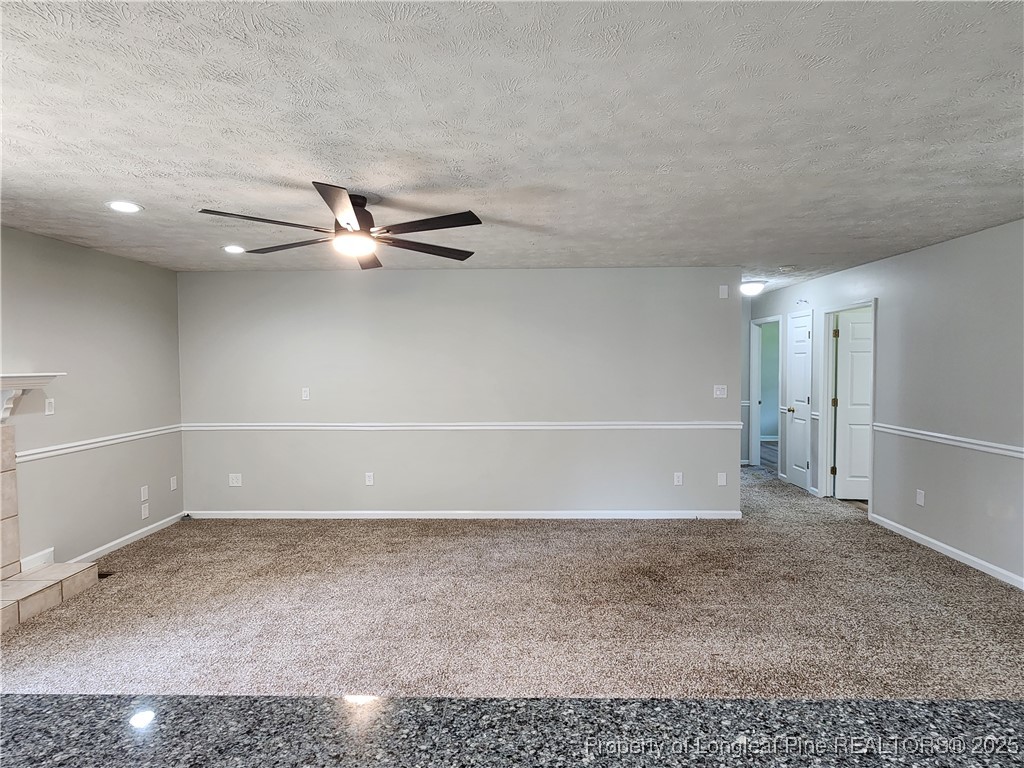 5444 Rockfish Road Raeford, NC 28376 - Photo 13 of 37 a view of a room with a empty space and a ceiling fan