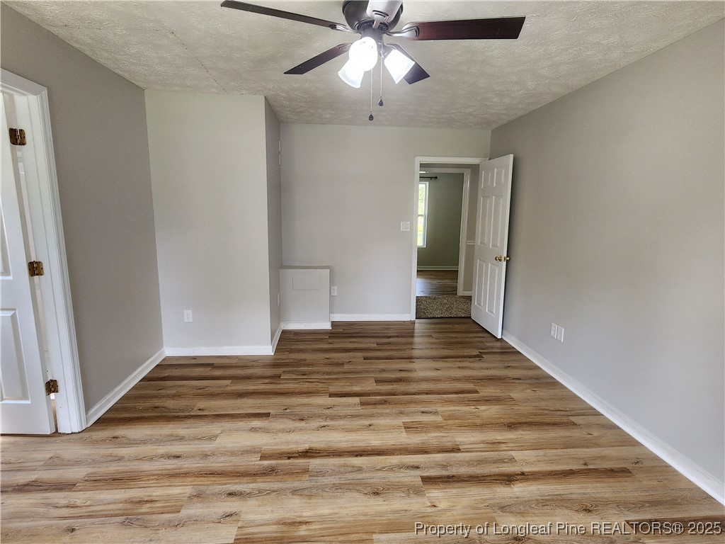 5444 Rockfish Road Raeford, NC 28376 - Photo 17 of 37 a view of empty room with wooden floor and fan