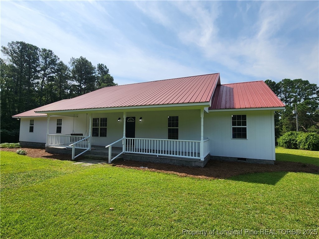 5444 Rockfish Road Raeford, NC 28376 - Photo 2 of 37 a front view of a house with garden
