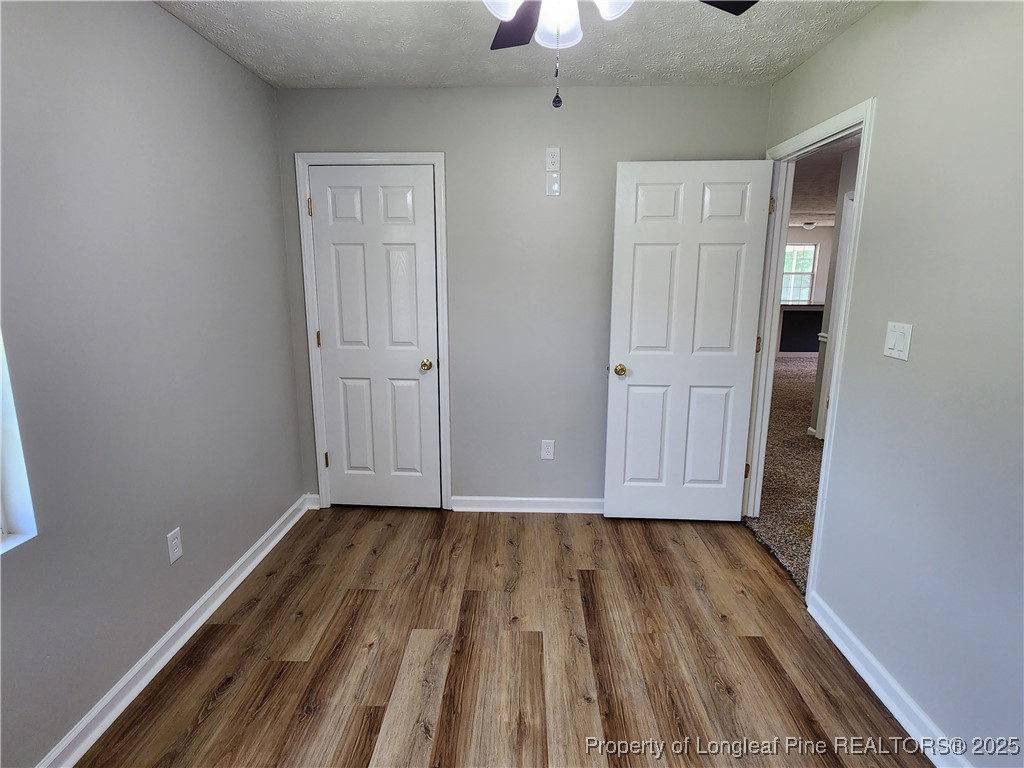 5444 Rockfish Road Raeford, NC 28376 - Photo 21 of 37 a view of a room with wooden floor staircase and a kitchen space