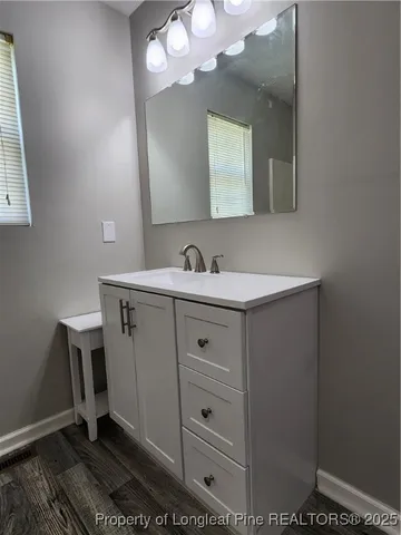 a bathroom with a sink a mirror and a toilet
