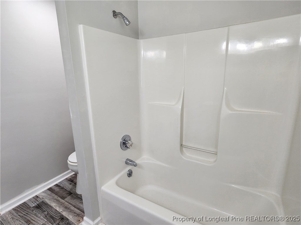 5444 Rockfish Road Raeford, NC 28376 - Photo 26 of 37 a bathroom with a bathtub and a shower