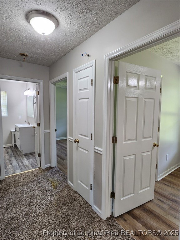 5444 Rockfish Road Raeford, NC 28376 - Photo 30 of 37 a view of a hallway with closet and wooden floor
