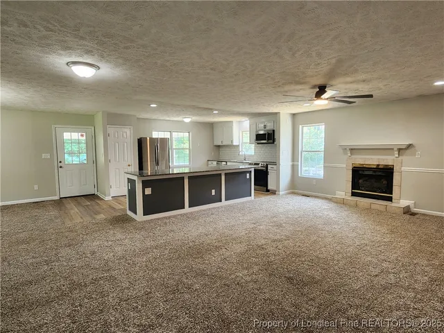 a view of a kitchen with a sink and a fireplace