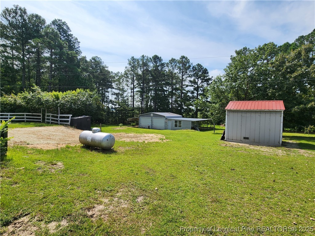 5444 Rockfish Road Raeford, NC 28376 - Photo 32 of 37 a view of a swimming pool with a bench and trees in the background