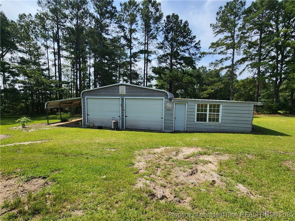 5444 Rockfish Road Raeford, NC 28376 - Photo 33 of 37 a backyard of a house with lots of green space