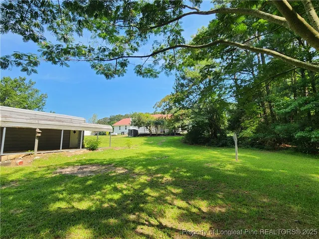 a view of a house with a backyard