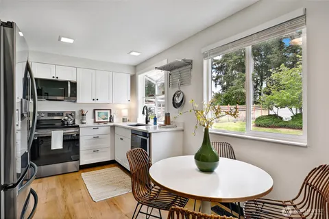 a kitchen with a table chairs stove and refrigerator