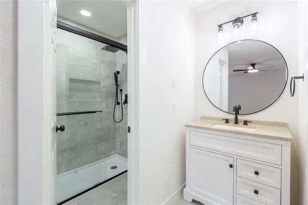 a bathroom with a sink a mirror and shower
