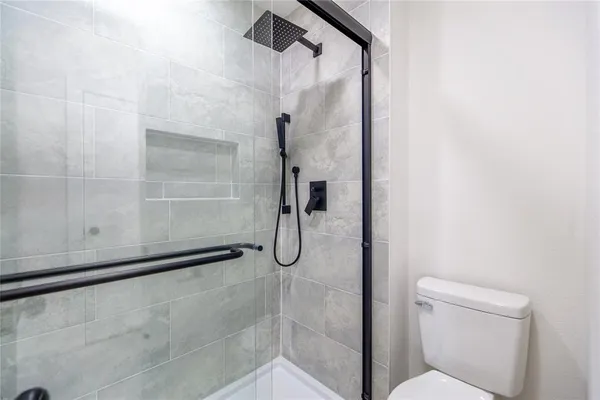 a bathroom with a glass shower door