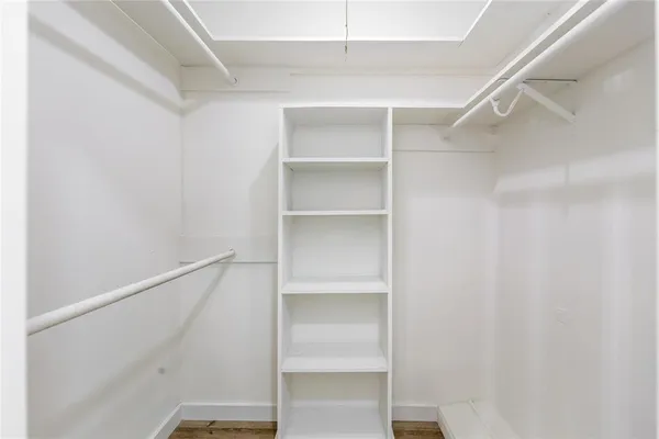 a view of walk in closet with empty racks