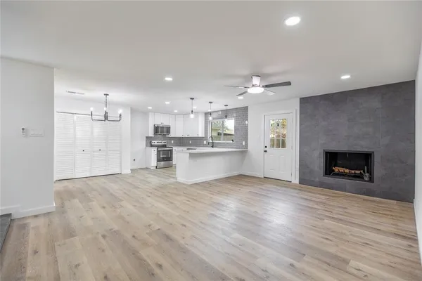 a view of a kitchen with a sink and a fireplace