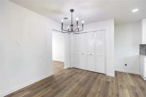 an empty room with wooden floor
