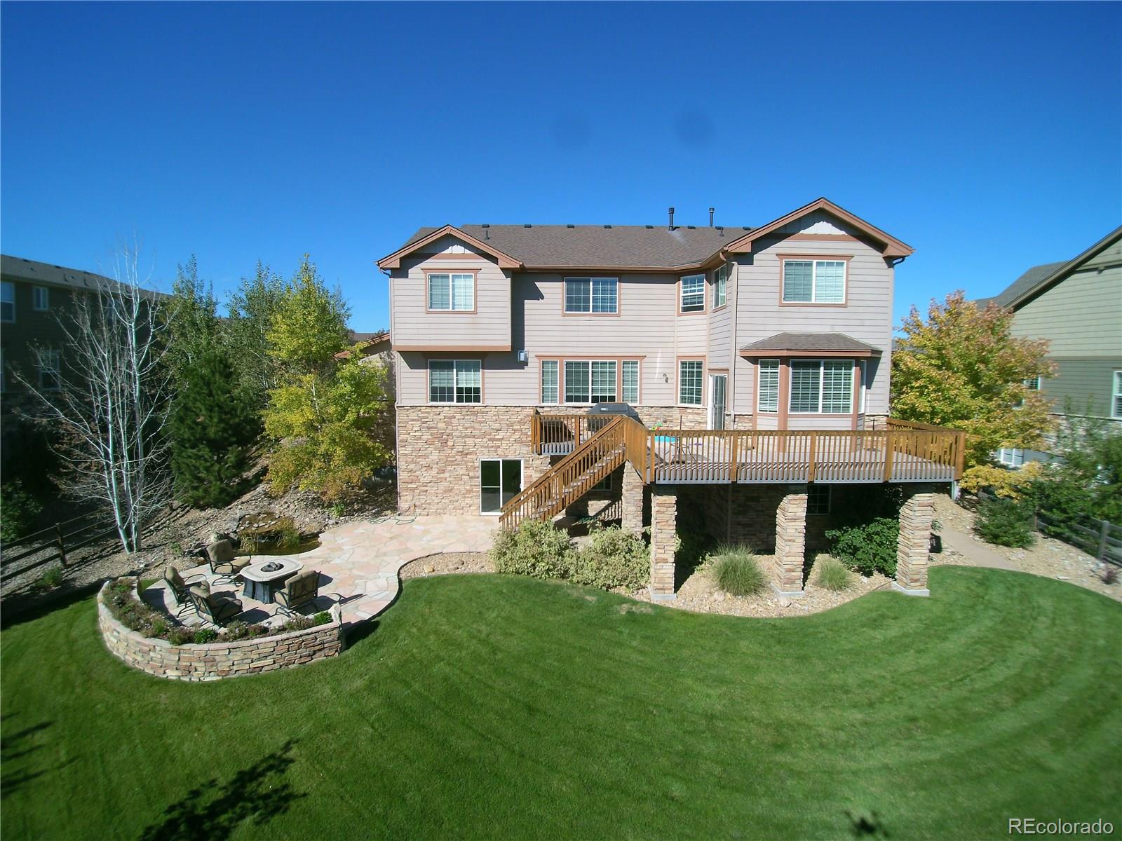 17874 West 77th Lane Arvada, CO 80007 - Photo 1 of 33 a view of a house with a yard patio and fire pit