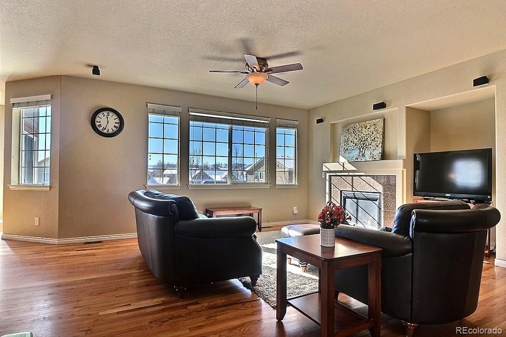 17874 West 77th Lane Arvada, CO 80007 - Photo 15 of 33 a living room with furniture and a flat screen tv