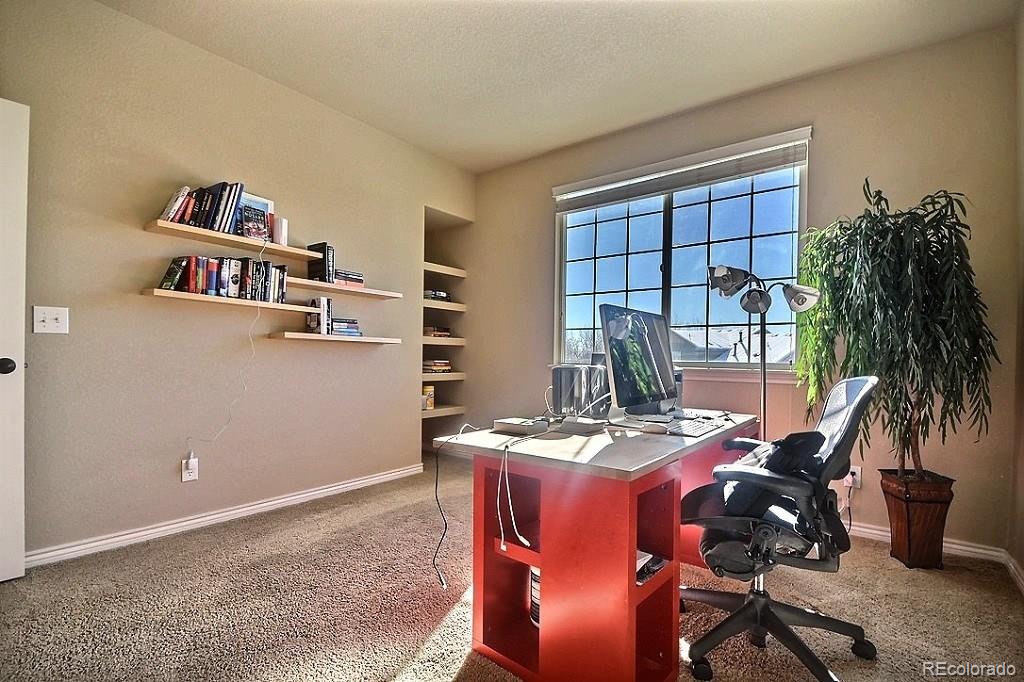 17874 West 77th Lane Arvada, CO 80007 - Photo 16 of 33 a room with furniture and window