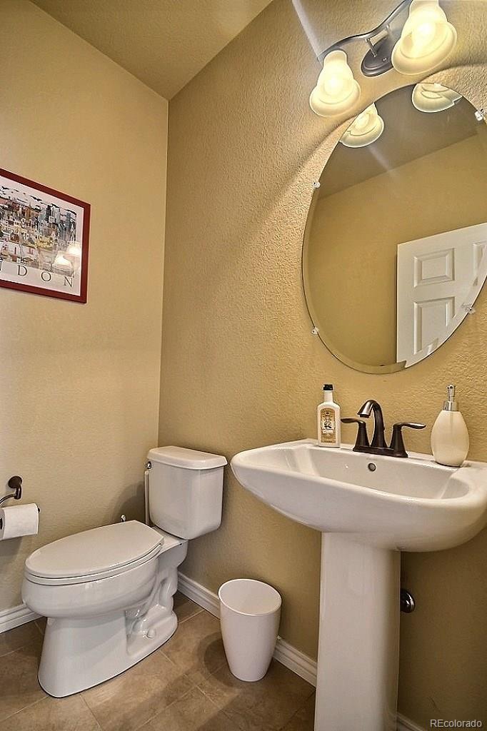 17874 West 77th Lane Arvada, CO 80007 - Photo 17 of 33 a bathroom with a toilet sink and mirror