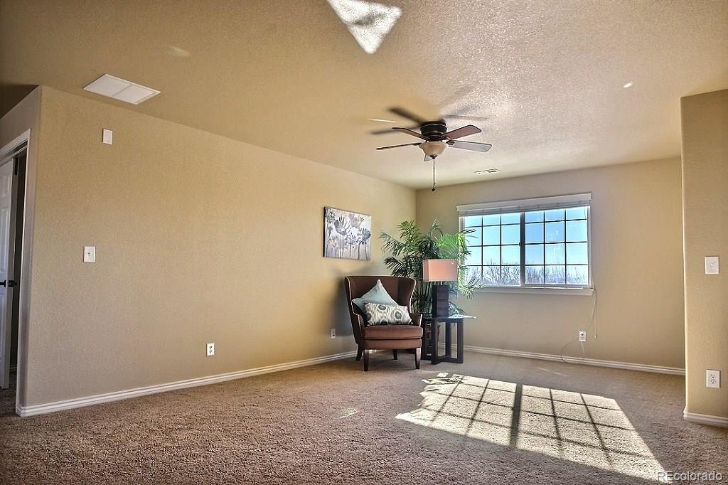 17874 West 77th Lane Arvada, CO 80007 - Photo 19 of 33 a view of a workspace with furniture and a window