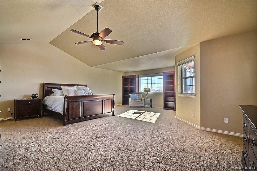 17874 West 77th Lane Arvada, CO 80007 - Photo 20 of 33 a living room with furniture and a chandelier