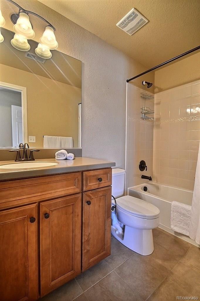 17874 West 77th Lane Arvada, CO 80007 - Photo 27 of 33 a bathroom with a sink a toilet a mirror and shower