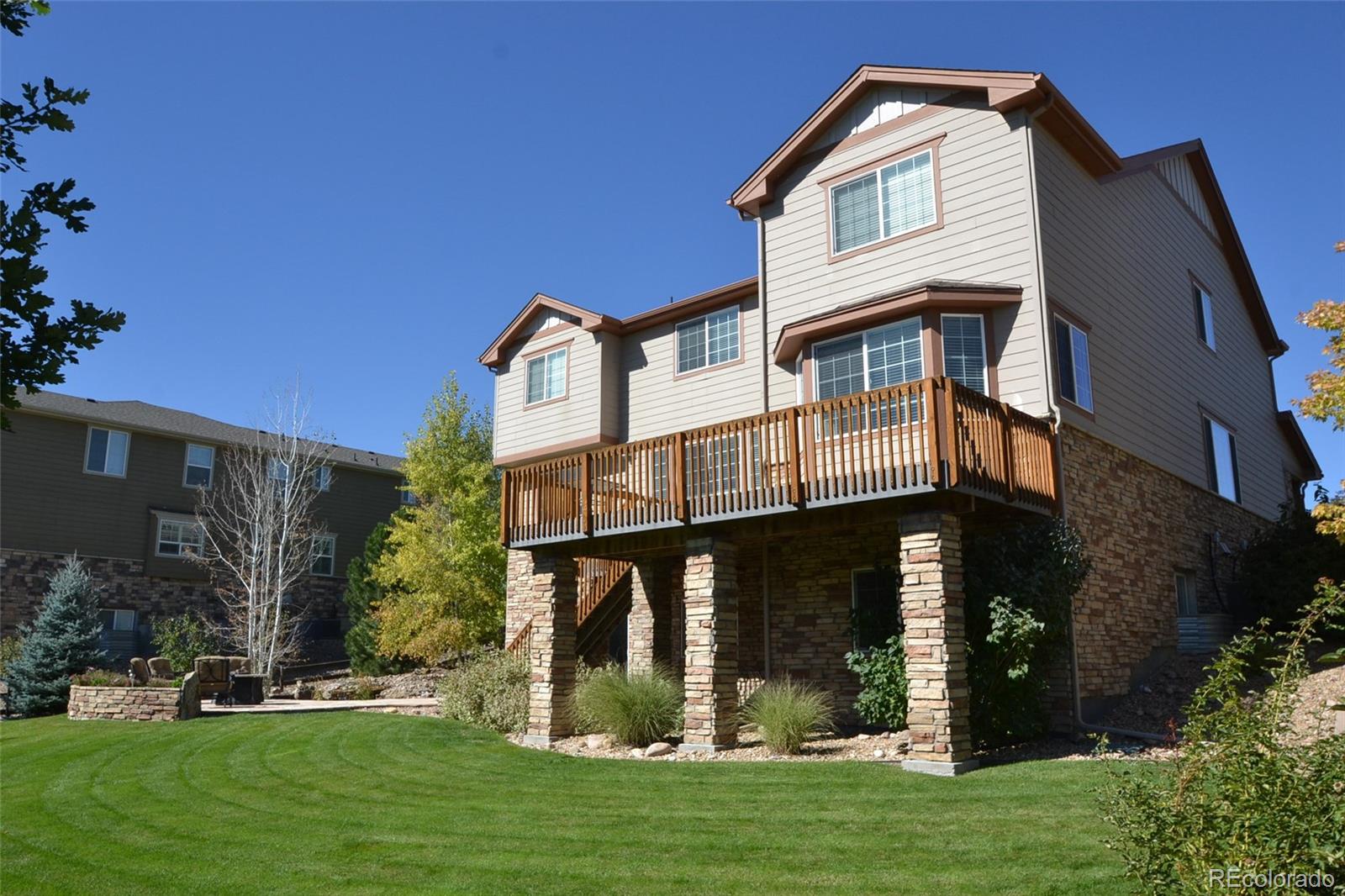 17874 West 77th Lane Arvada, CO 80007 - Photo 3 of 33 a front view of a house with a yard