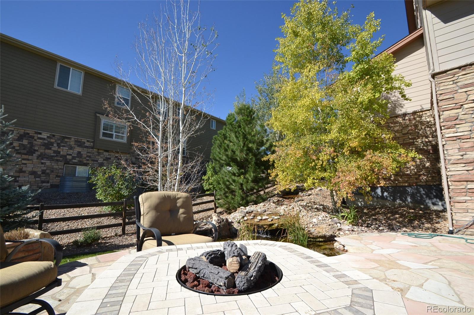 17874 West 77th Lane Arvada, CO 80007 - Photo 4 of 33 a view of a chairs and table in backyard