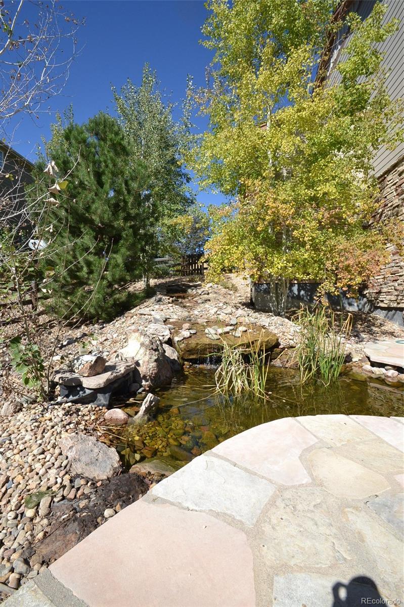 17874 West 77th Lane Arvada, CO 80007 - Photo 5 of 33 a view of a backyard of a house