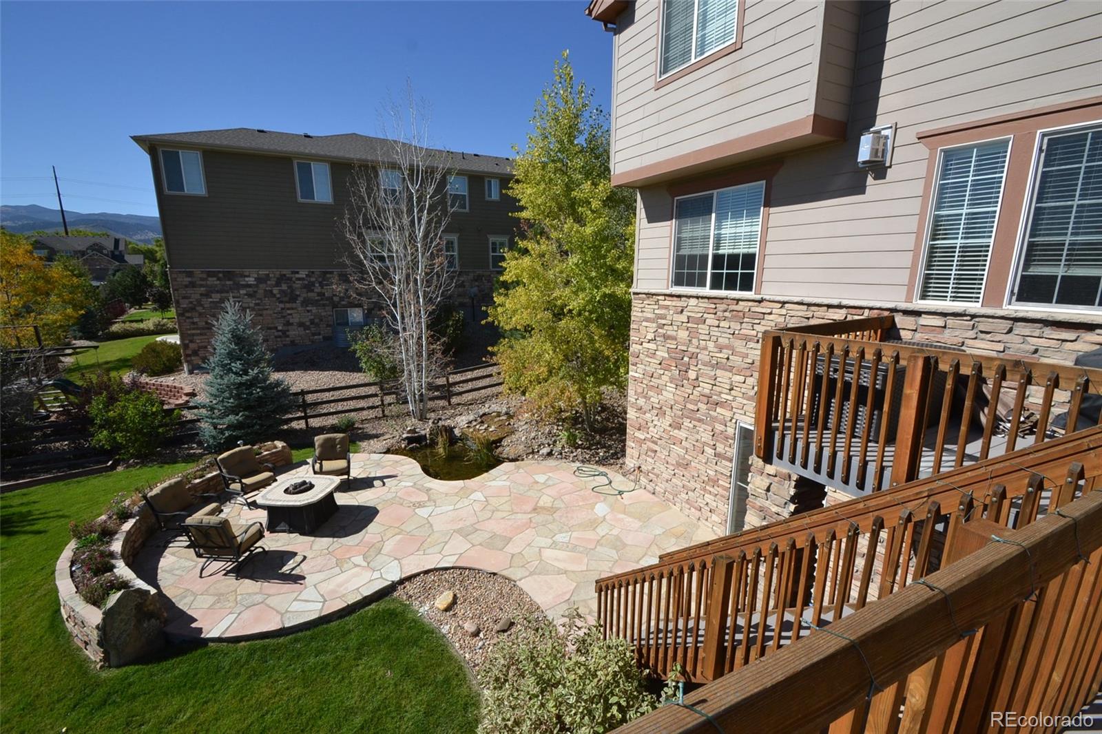 17874 West 77th Lane Arvada, CO 80007 - Photo 6 of 33 a view of a house with backyard and sitting area