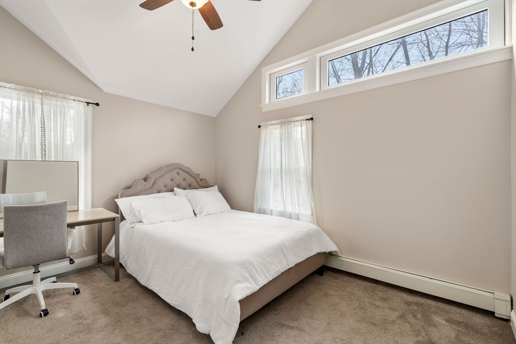 518 Maple Street Danvers, MA 01923 - Photo 11 of 20 a bedroom with a bed and a chandelier