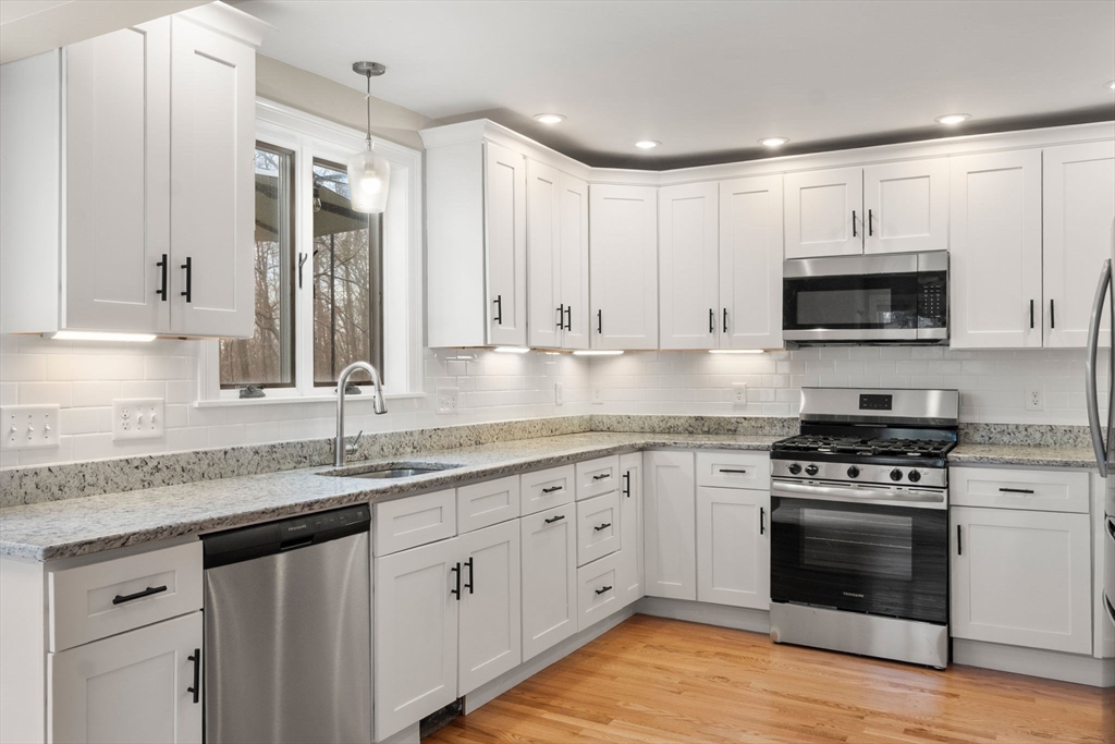 518 Maple Street Danvers, MA 01923 - Photo 6 of 20 a kitchen with granite countertop a sink cabinets and stainless steel appliances