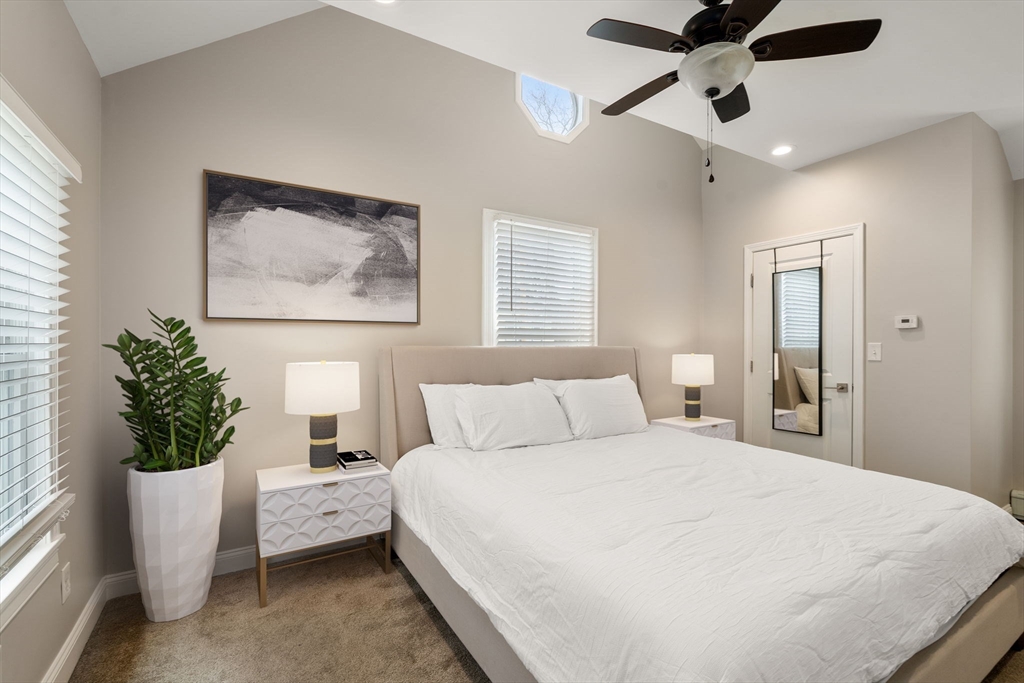 518 Maple Street Danvers, MA 01923 - Photo 8 of 20 a bedroom with a large bed and a potted plant