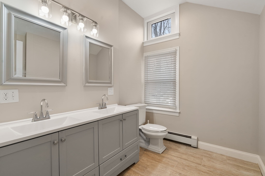 518 Maple Street Danvers, MA 01923 - Photo 9 of 20 a bathroom with a toilet a sink and mirror