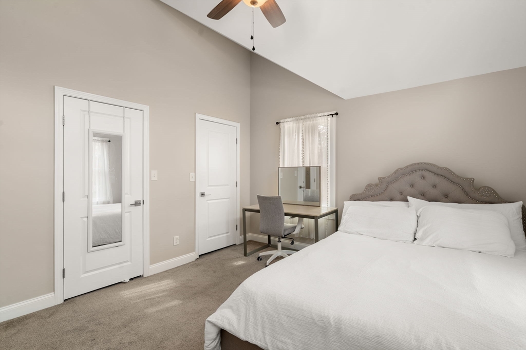 518 Maple Street Danvers, MA 01923 - Photo 10 of 20 a bedroom with a bed and a chandelier