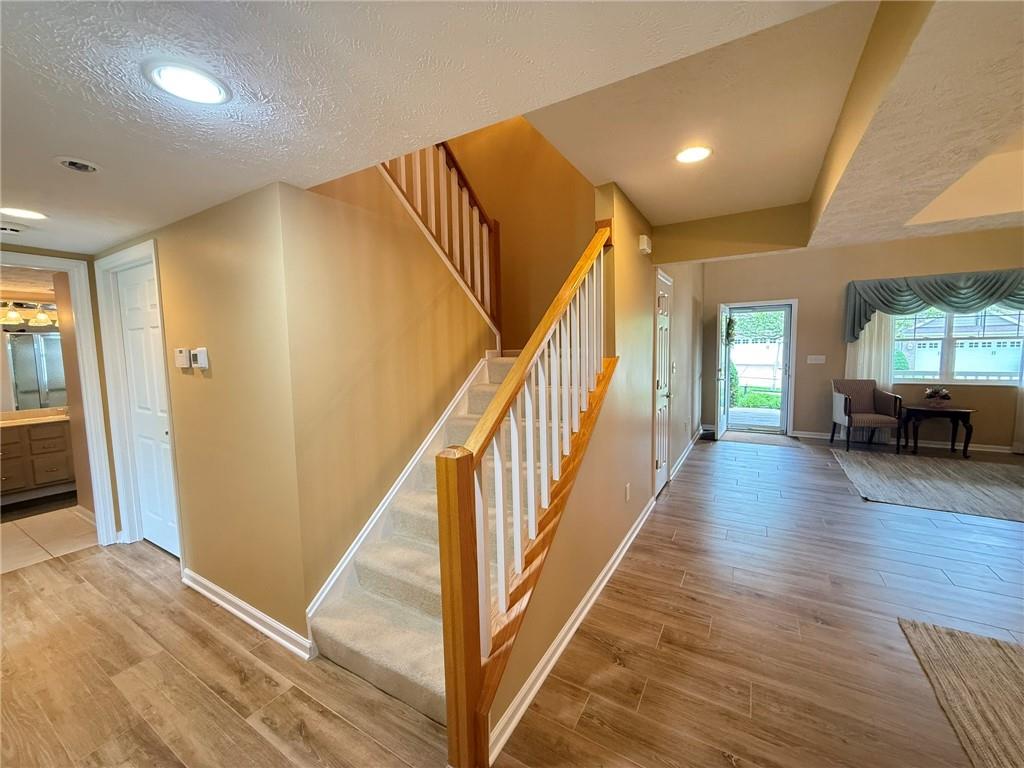 411 Chestnut Lane Apollo, PA 15613 - Photo 16 of 38 a view of a livingroom with wooden floor and stairs