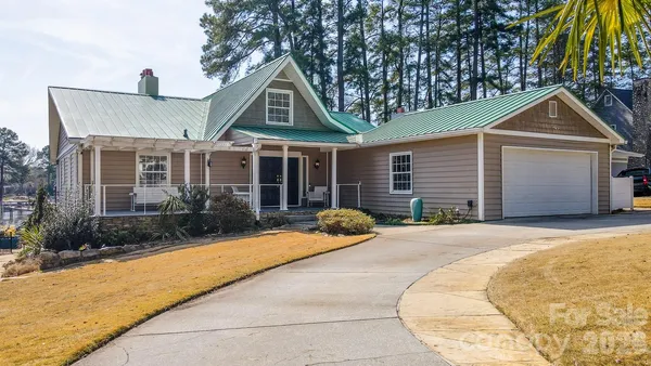 a front view of a house with yard and glass windows