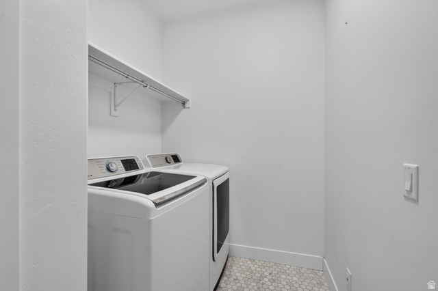 36 West Syracuse Road Vineyard, UT 84059 - Photo 21 of 56 Dedicated laundry area featuring a white wall shelf with a hanging rod, white walls, and hexagonal floor tiling