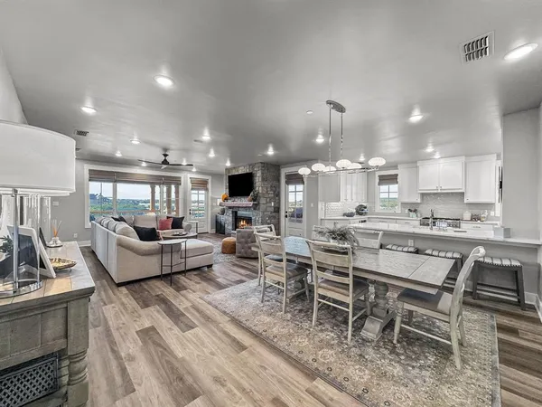 a living room with lots of furniture and kitchen view