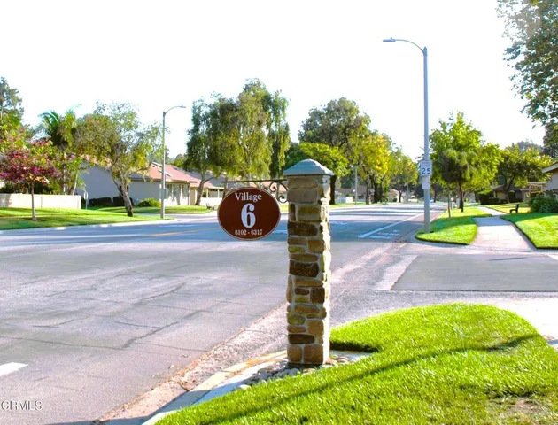 a view of a park with potted plants