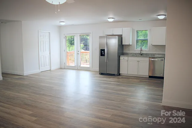 a view of a kitchen with a sink and a refrigerator