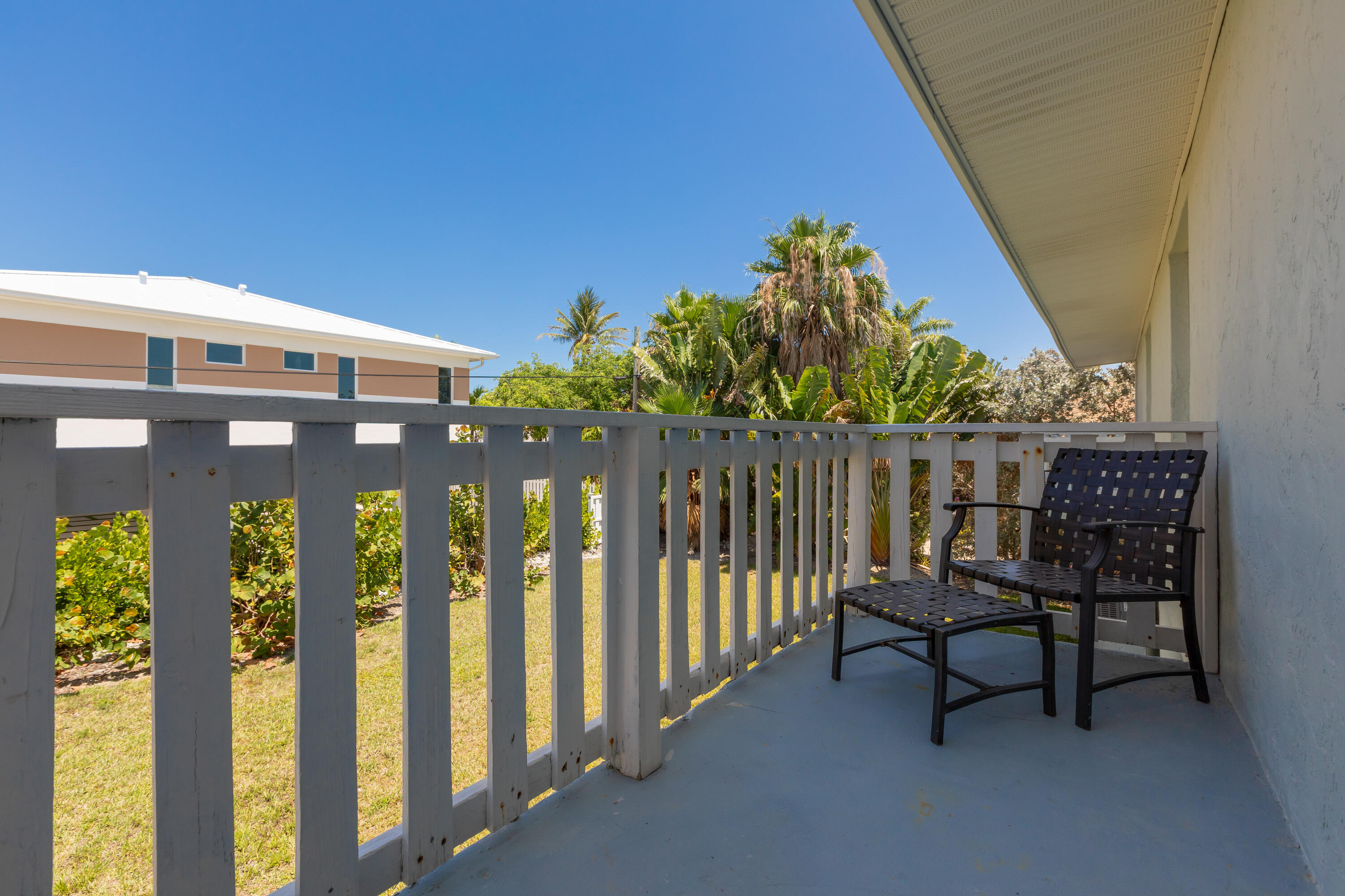 280-290 3rd Street Key Colony Beach, FL 33051 - Photo 24 of 28 a view of a chair and table in the balcony